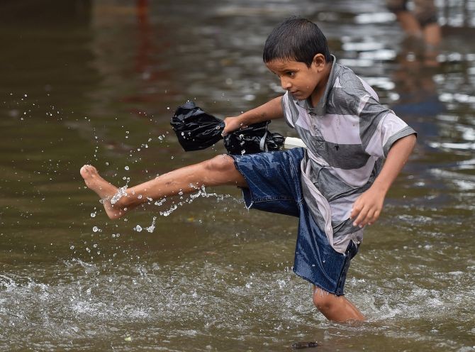  A man wades through a waterlogged street during monsoon rain, at Sion in Mumbai, Sunday, July 5, 2020. Heavy rains continued to lash Mumbai, Thane and other parts of Konkan Maharashtra for the third consecutive day on Sunday. (PTI Photo/Kunal Patil)